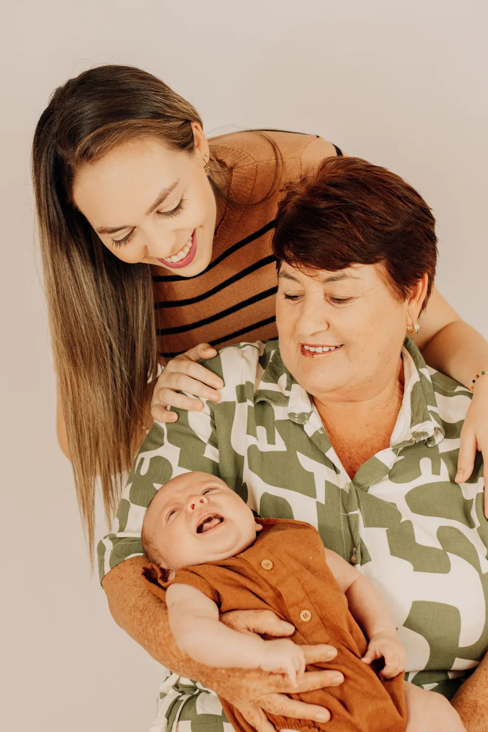Avó, mãe e bebê sorrindo juntas